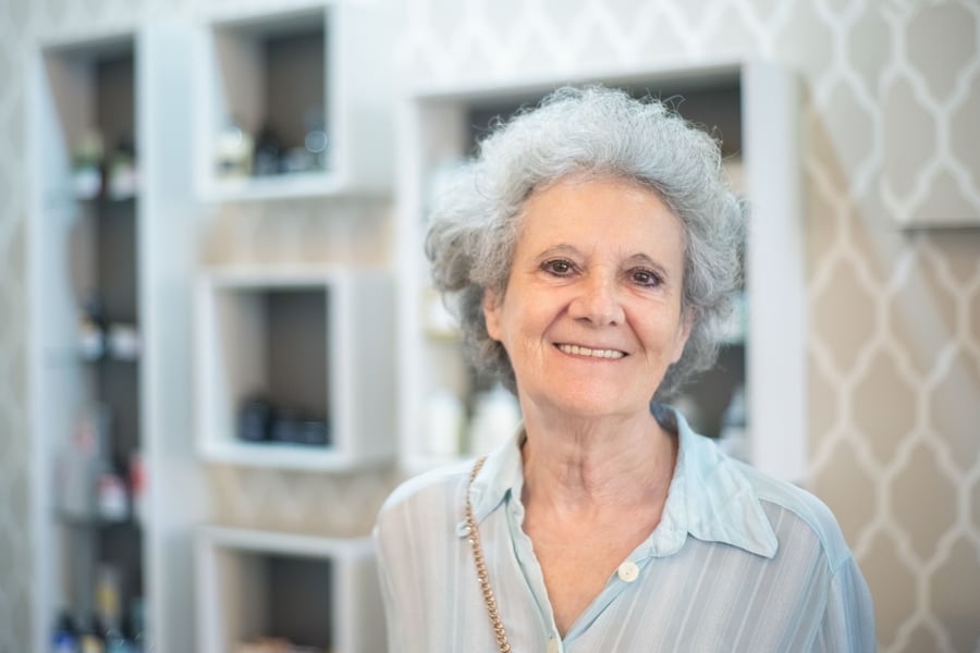 A patient smiling at her camera during a telehealth consult.
