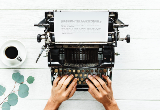 Writing on a typewriter - with a cup of coffee