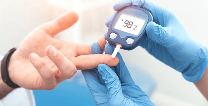 Person receiving a blood glucose test for diabetes