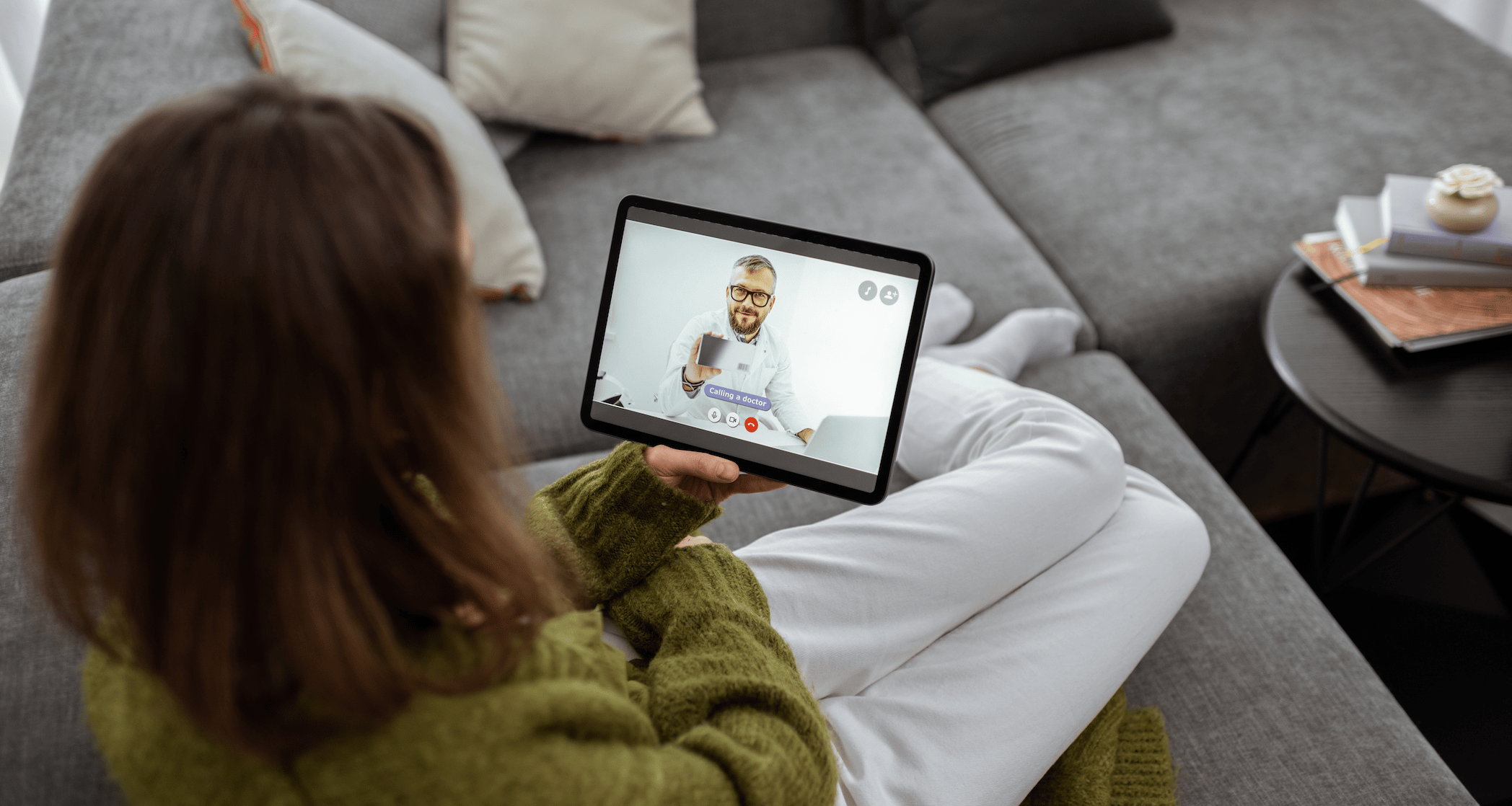Patient sitting on couch using telehealth